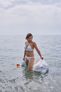 Full length of woman in sea against sky