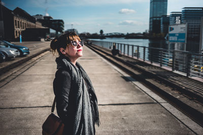 Woman standing on city street