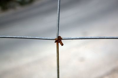 Close-up of metals tied with rusty wire