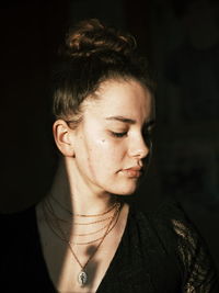 Close-up portrait of a young woman looking away