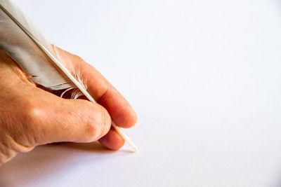 Close-up of man hand over white background