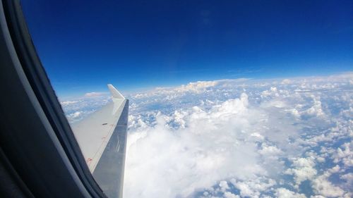 Aerial view of aircraft wing against sky