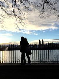 Silhouette of man on bridge against sky