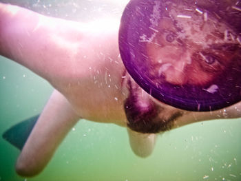 Close-up of man swimming in sea