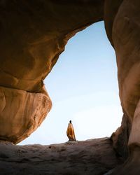 Low section of man standing on rock formations