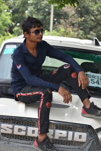 Full length of man sitting in car