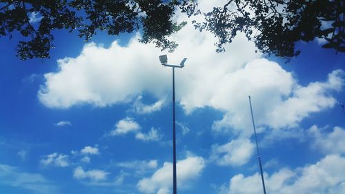 Low angle view of street light against blue sky