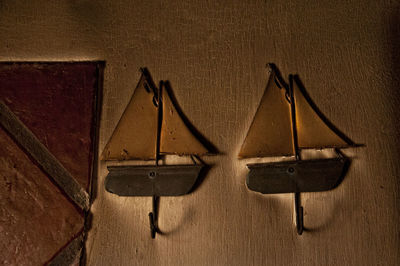 Close-up of old electric lamp hanging on wall