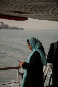 Rear view of man standing in boat