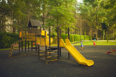 View of playground against trees in park