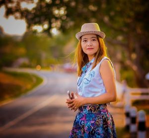 Portrait of girl wearing hat standing outdoors