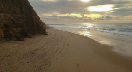 Scenic view of beach against sky during sunset