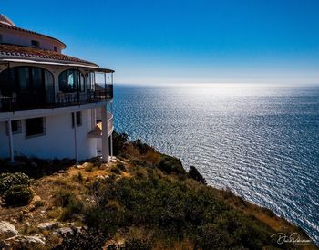 Scenic view of sea against clear blue sky