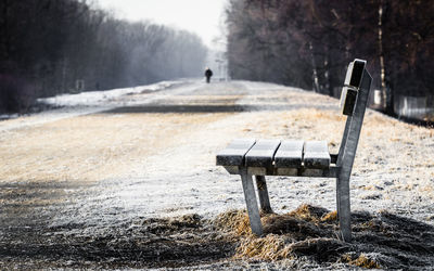 Frosty park bench winter time desaturated colors