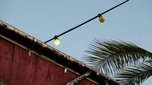 Low angle view of power lines against clear sky