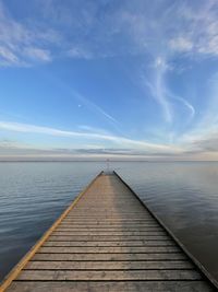 Pier over lake against sky