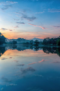 Scenic view of lake against romantic sky at sunset