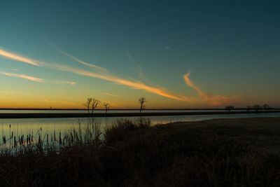 Scenic view of lake against sky during sunset