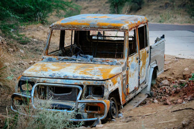 Abandoned car on field