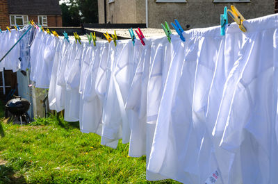 Clothes drying on clothesline in field