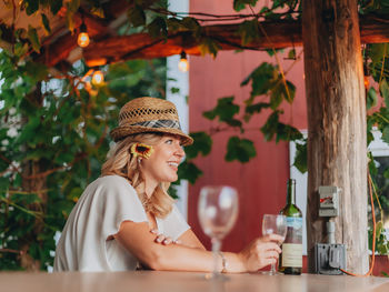 Portrait of a smiling young woman drinking glass