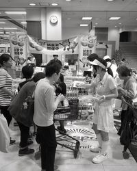 People standing on display at store