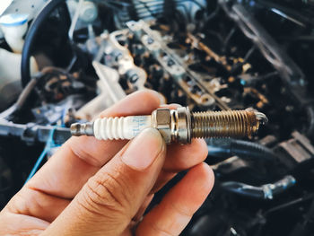 Close-up of person holding metal