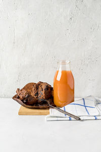 Close-up of drink on table against white background