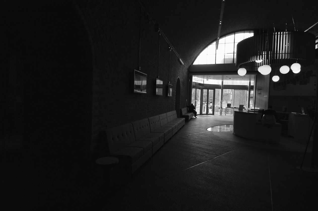 indoors, illuminated, architecture, built structure, lighting equipment, night, empty, architectural column, corridor, ceiling, absence, the way forward, electric light, no people, column, building, flooring, dark, entrance, door