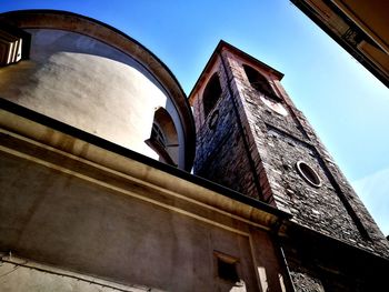 Low angle view of old building against clear blue sky