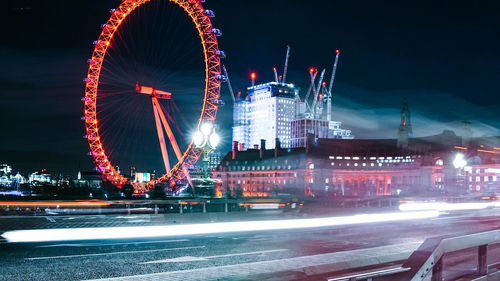 Illuminated ferris wheel at night