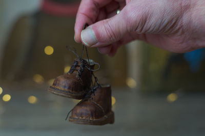 Brown leather small shoes with small feet for teddy bears, dolls and for children and their parents