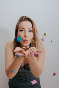 Portrait of beautiful woman standing against white background