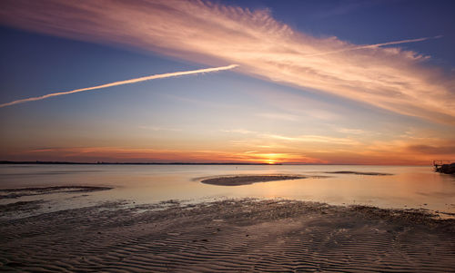 Scenic view of beach against sky during sunset