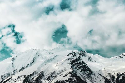 Scenic view of snow covered mountains against sky