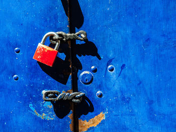 Close-up of padlock on blue door