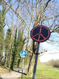 Close-up of road sign against bare trees