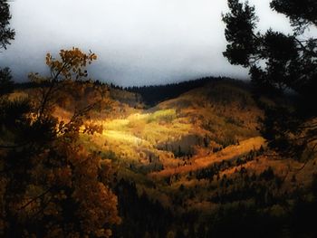 Scenic shot of countryside landscape against mountain range