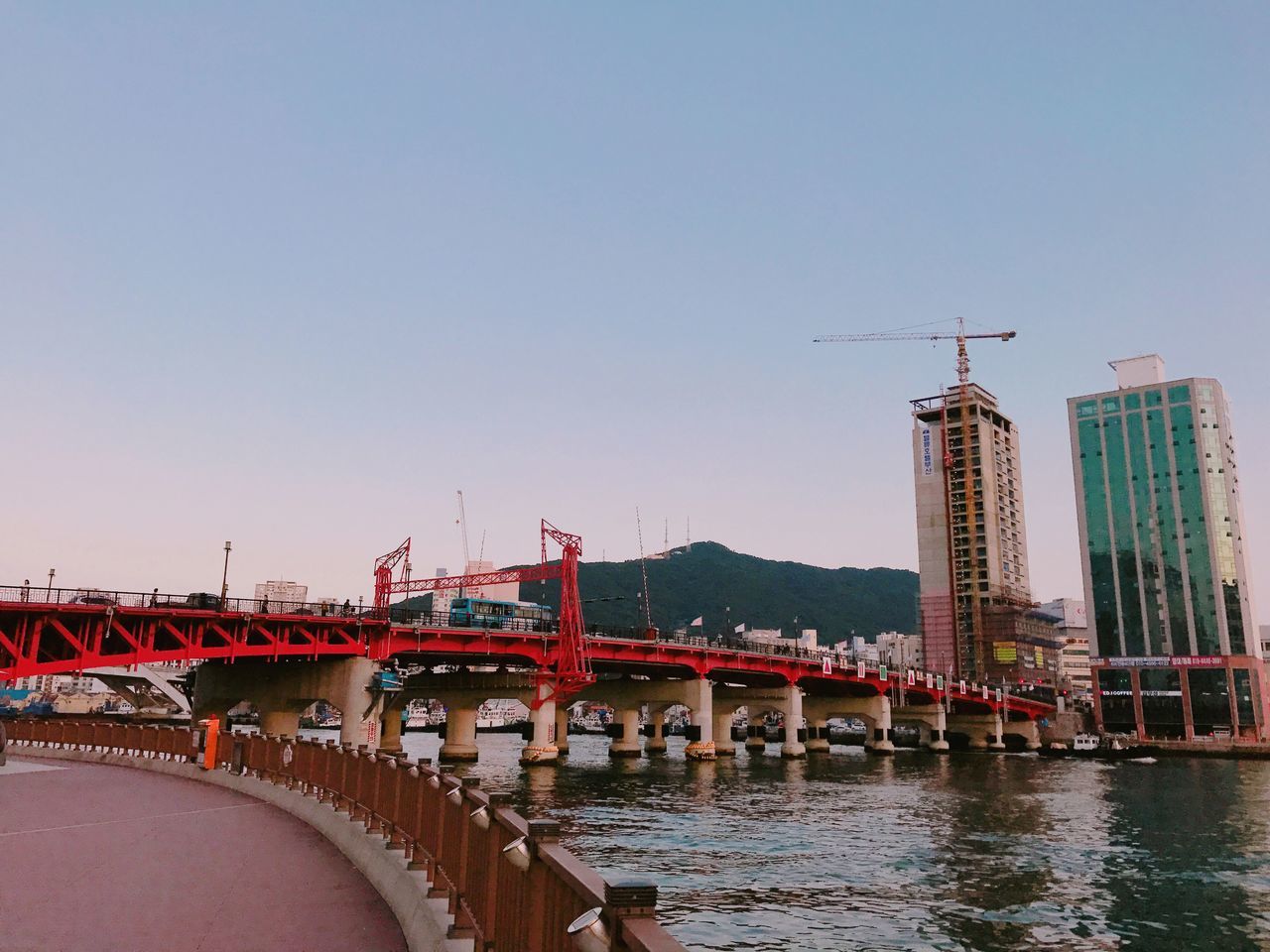 architecture, bridge - man made structure, built structure, connection, river, building exterior, city, transportation, bridge, waterfront, outdoors, clear sky, water, no people, day, sky