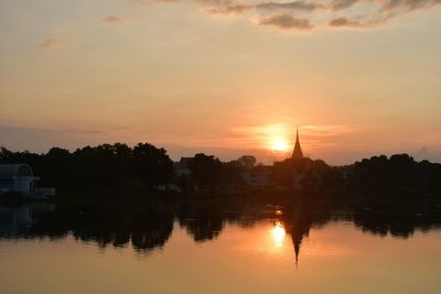 Scenic view of lake against orange sky