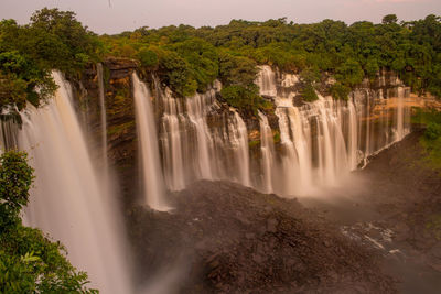 Fountain against waterfall