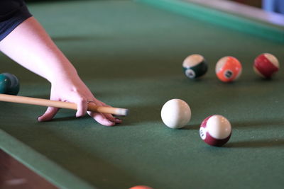 Cropped hand playing pool