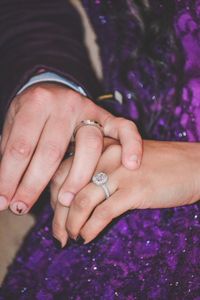 Midsection of couple wearing rings during wedding ceremony