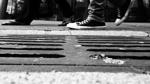 Low section of people walking on street