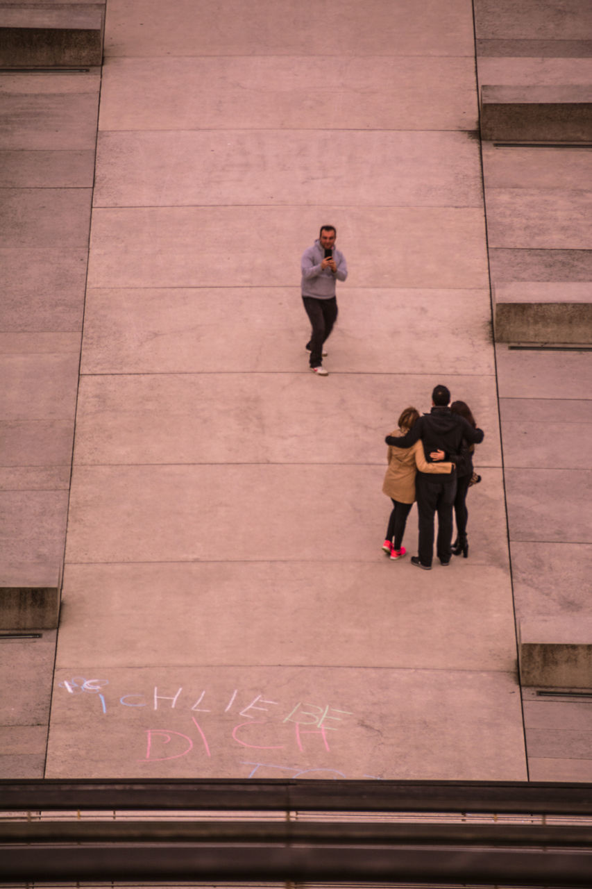 HIGH ANGLE VIEW OF TWO PEOPLE ON FLOOR