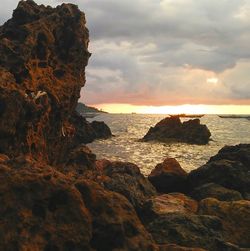 Scenic view of sea against cloudy sky