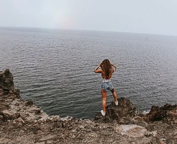 Person looking at sea against sky