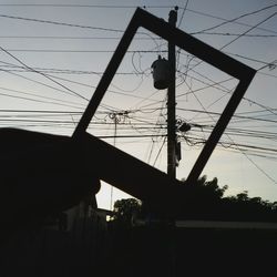 Low angle view of electricity pylon against sky