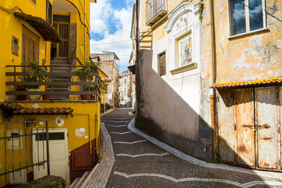 Street amidst buildings against sky