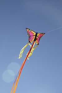 Low angle view of kite flying against clear sky